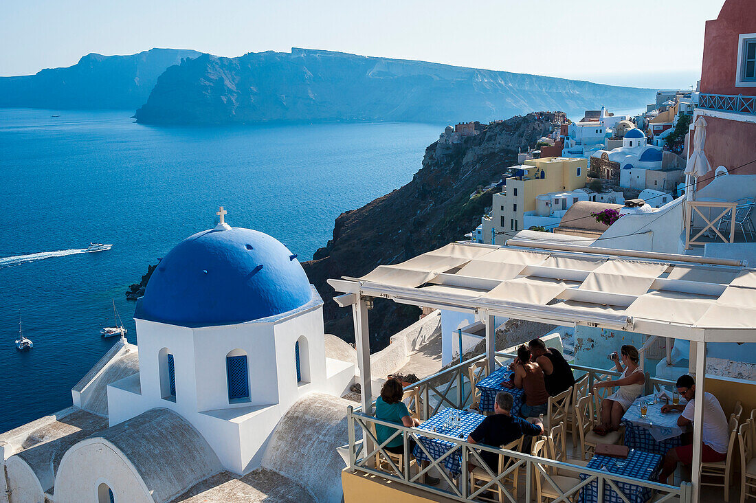 View of the Aegean sea and buildings on the hillside above, Oia, Santorini, Greece