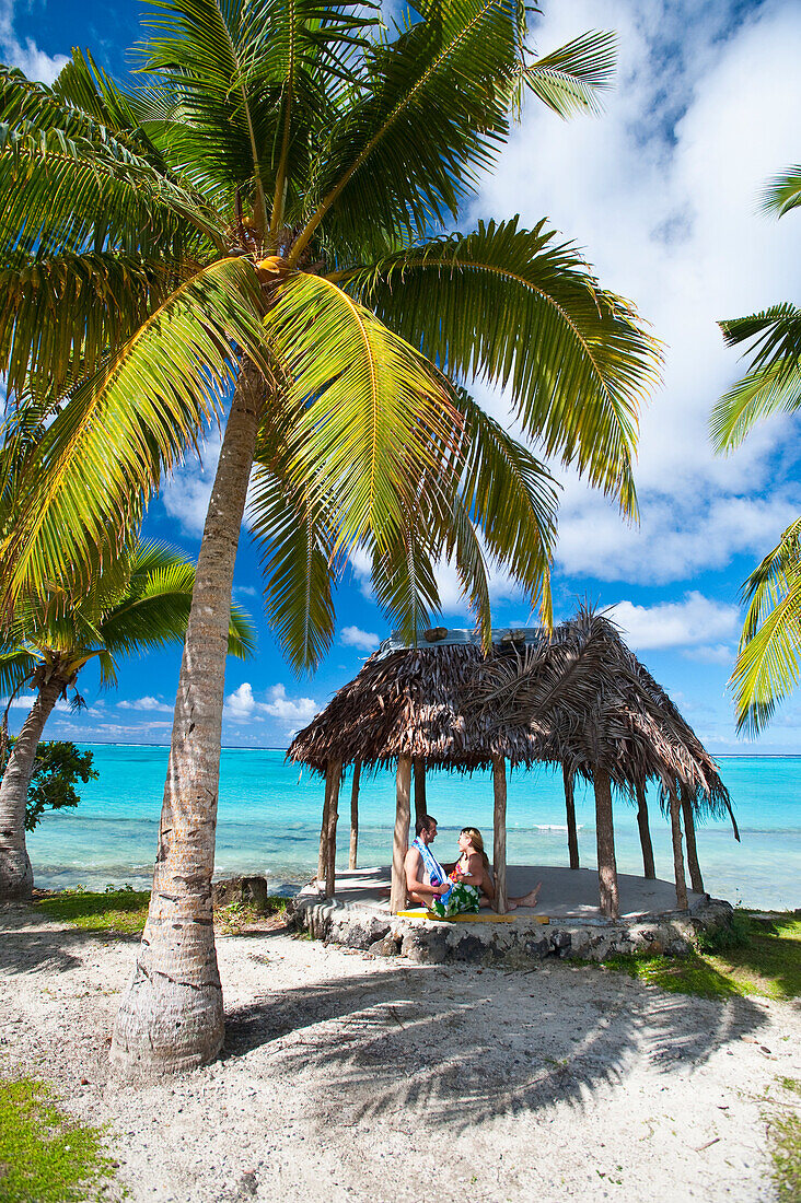 A couple in a beach fale (hut), Savaii Island, Samoa