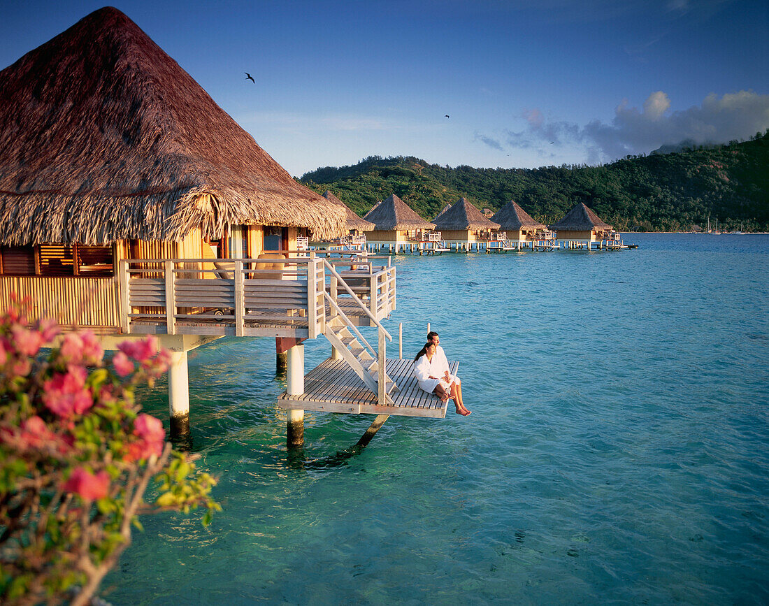 Couple relaxing at an overwater bungalow, Bora Bora