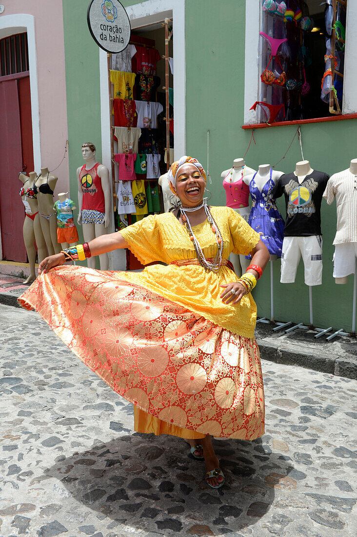 Brazilian woman wearing traditional clothes of the Bahia region in Salvador da Bahia, the city of the Holy Saviour of the Bay of all Saints on the northeast coast of Brazil , South America