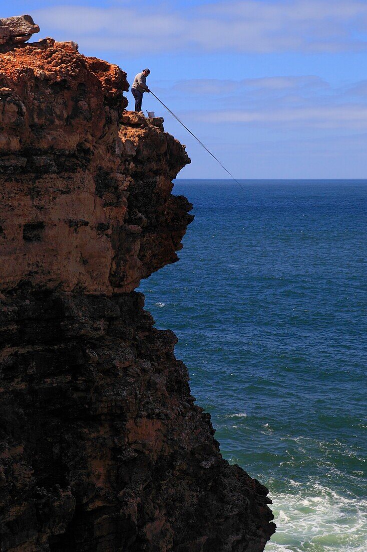 Portugal Algarve, Sagres, Fisherman at the top of the cliff
