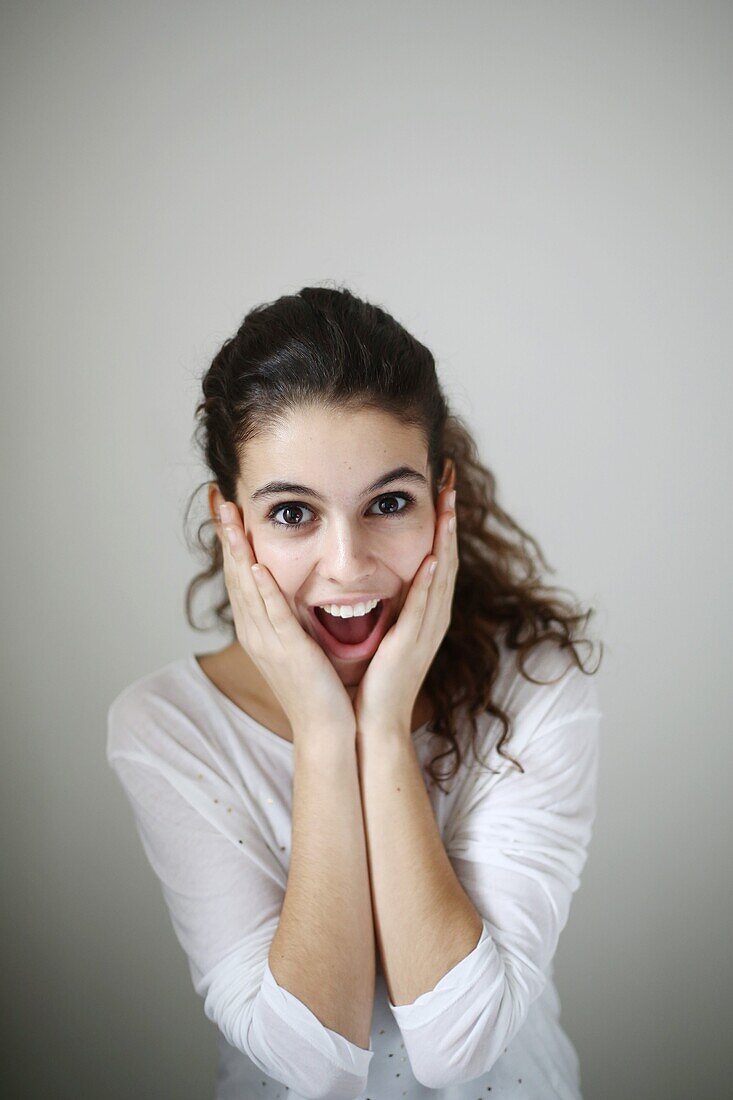 Portrait of a teenage girl, she seems to be surprised