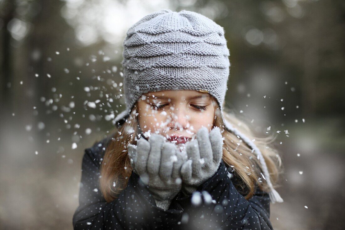 Girl holding snow in her hands