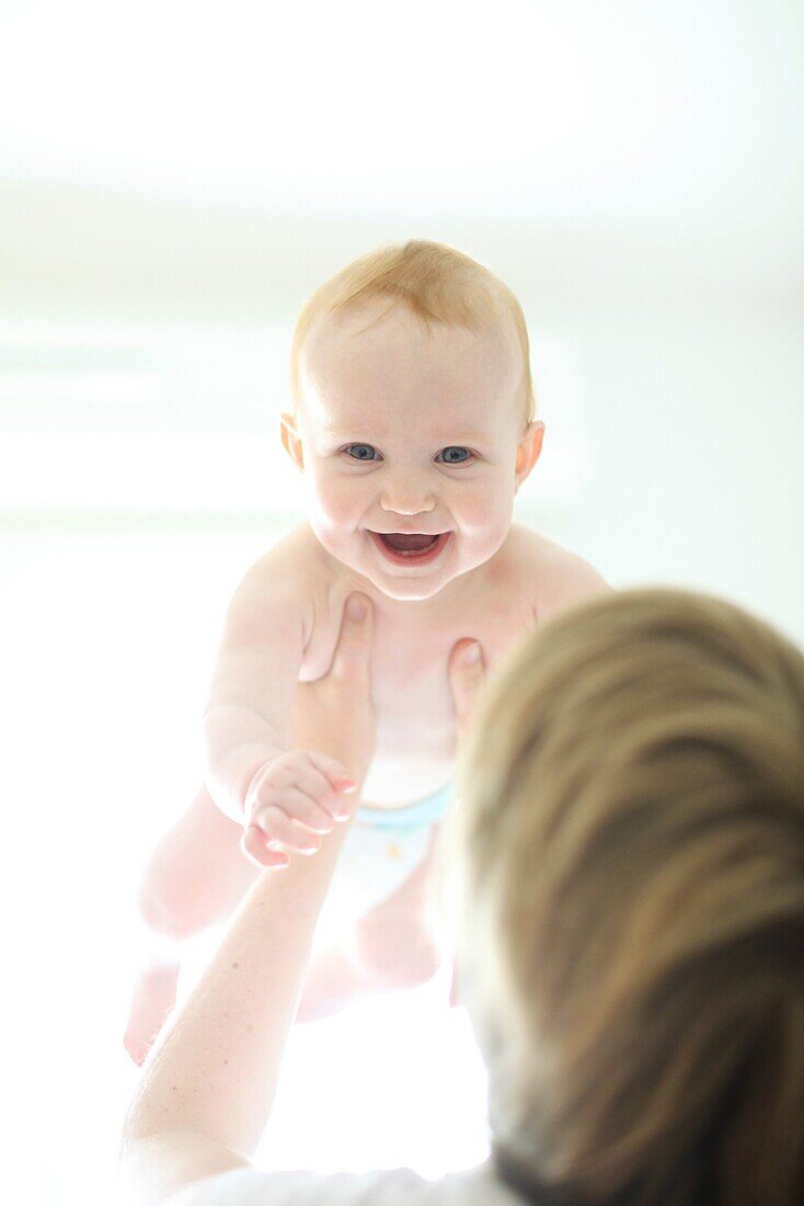 Woman holding baby up