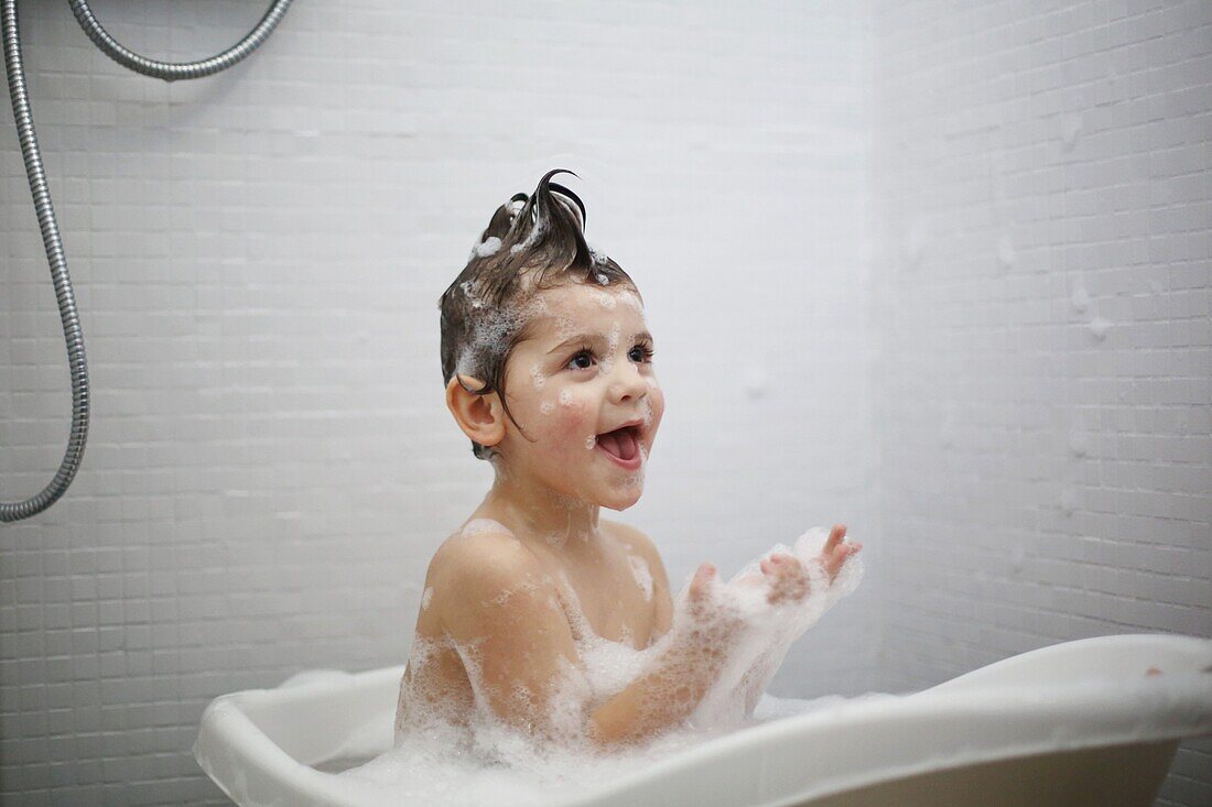 A little boy taking a bath