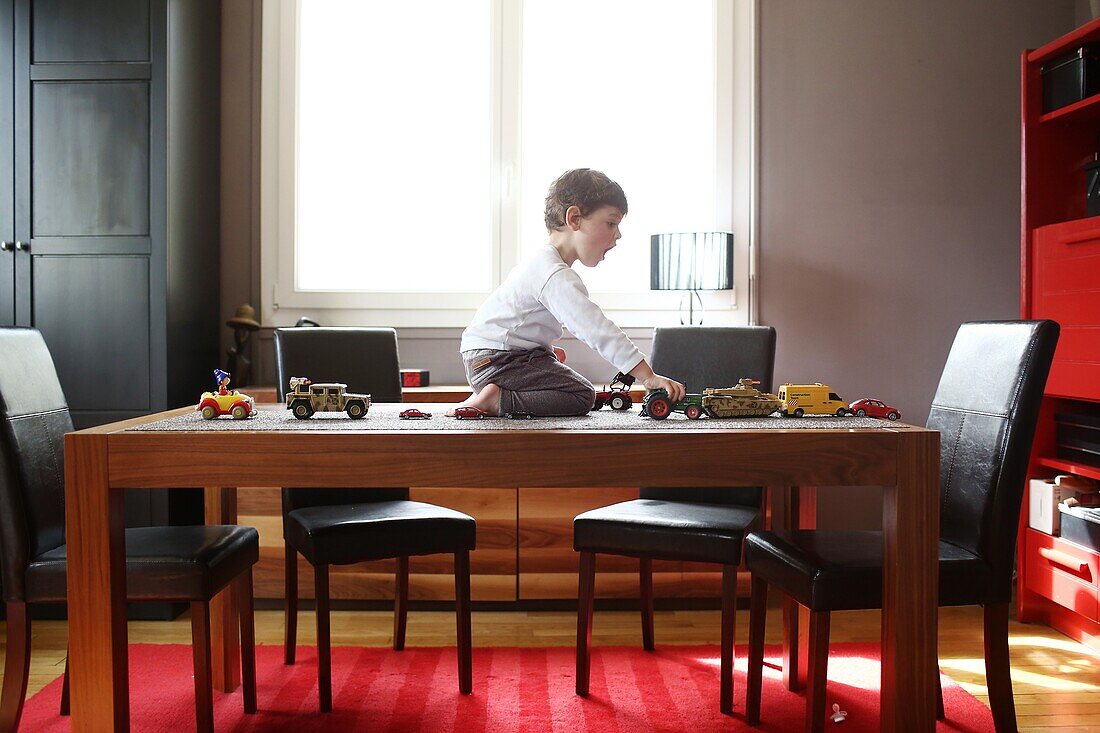 A little boy playing on the table