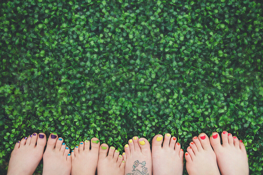 Close up of painted toenails or girls in grass