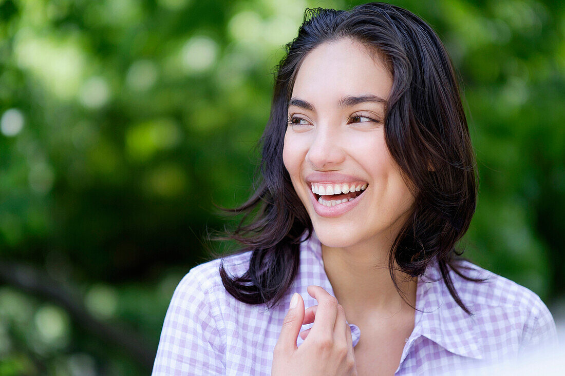 Hispanic woman laughing outdoors