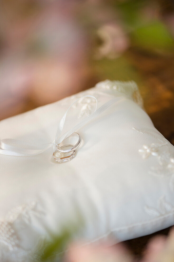 Close up of wedding rings on ring pillow