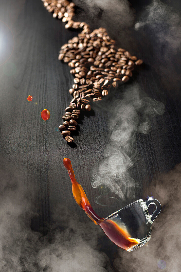 Coffee Cup Floating Through Steam Above Black Table with Coffee Beans