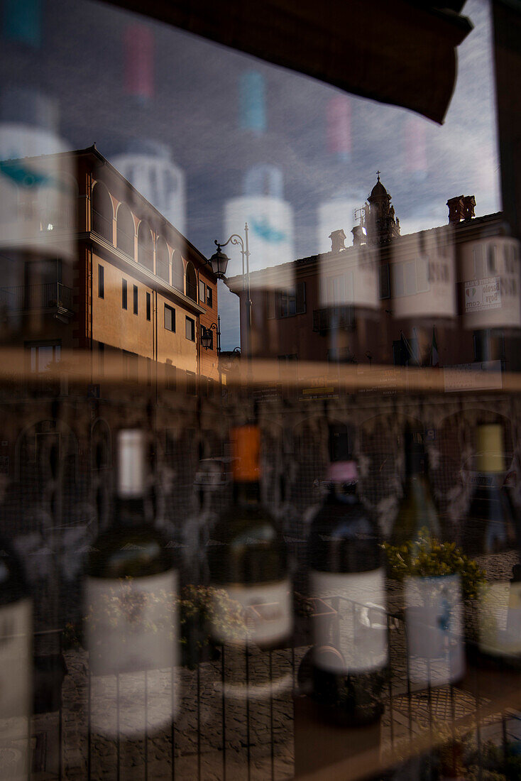 Buildings Reflected in Window of Wine Shop, Monforte d’Alba, Italy