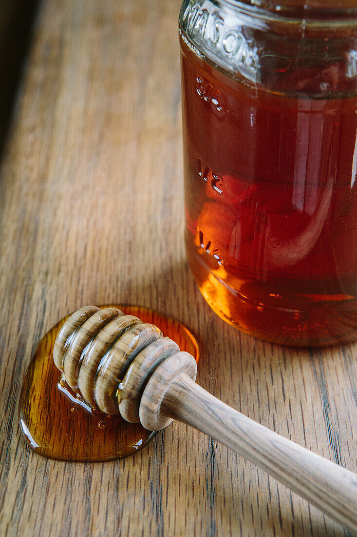 Honey and Dipper on Wood Table