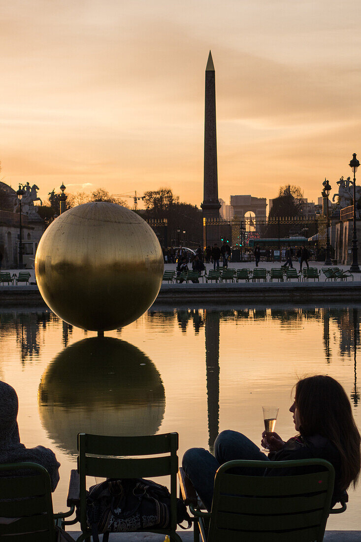 the obelisk on the place de la concorde and tourists with a glass of champagne around the octagonal pond in the tuileries garden, gilded bronze globe by james lee byars, 1st arrondissement, paris (75), france