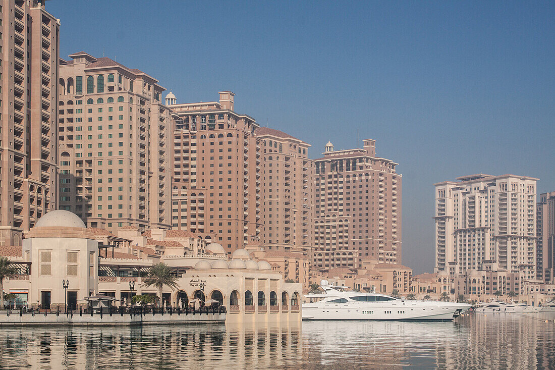 luxury yachts docked in the marina of porto arabia on the man-made peninsula the pearl, doha, qatar, persian gulf, middle east