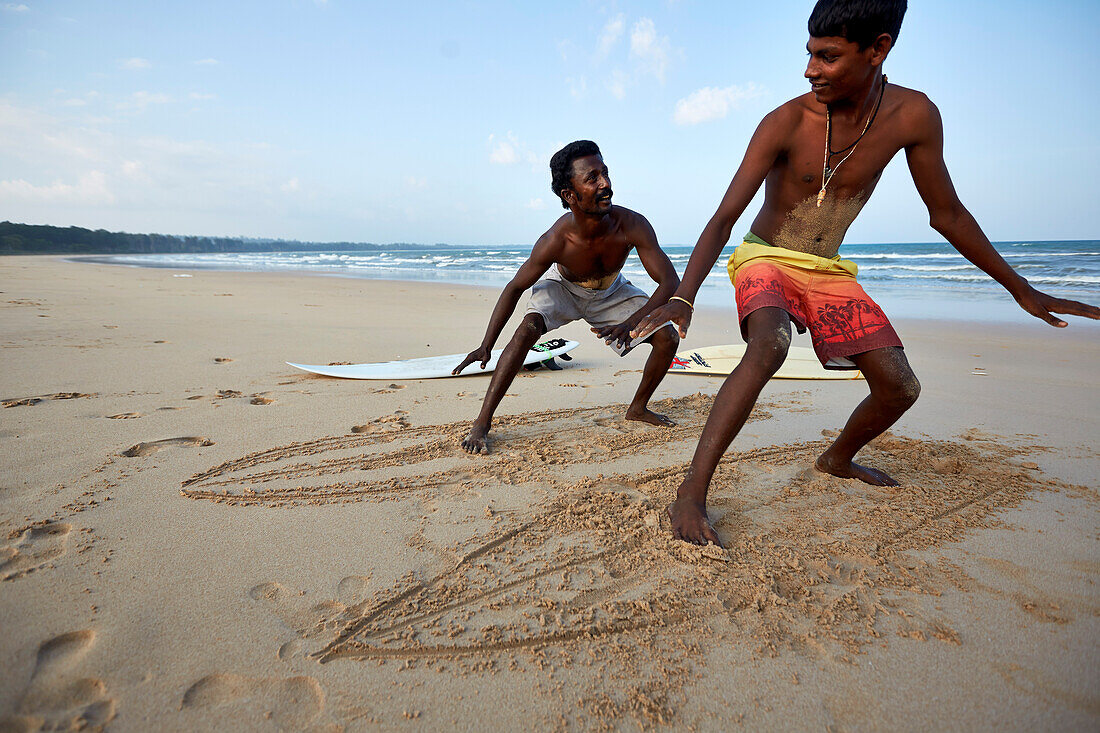 Surfer Thomas Arland, ''Motu', 38 Y., and his student Simhachalam, 18 Y., on the beach of Hat Bay, main town of Little Andaman, Andaman Islands, Union Territory, India