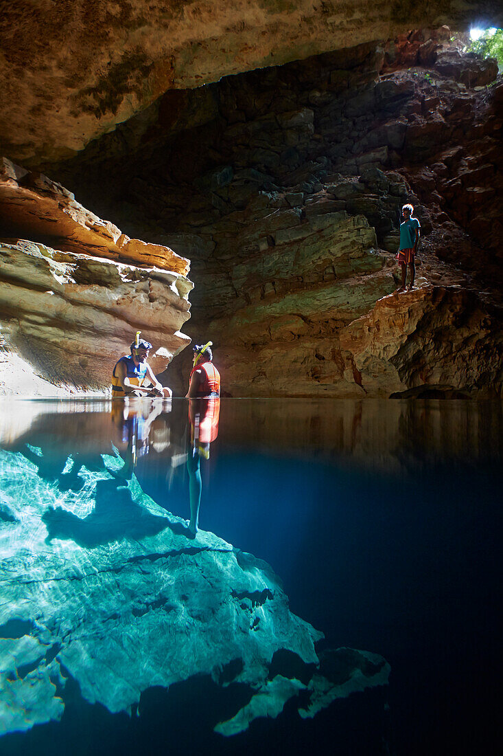 Besucher baden in Poco Azul, Sonnenstrahl, unterirdischer Fluss, archaeologische Fundstaette, oestlich des Chapada Diamantina National Park, Andarai, Bahia, Brasilien