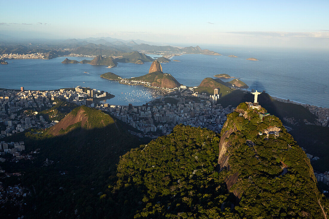 Cristo Redentor (Christ the Redeemer) statue on Corcovado Mountain, Tijuca Forest in the southern part of town, facing east over Baia de Guanabara, Sugar Loaf Mountain, helicopter tour, Rio de Janeiro, Brazil