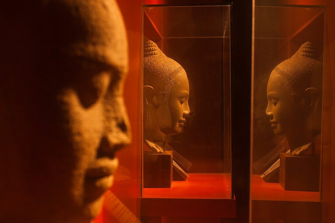 'Camdodia, Siem Reap Province, Siem Reap Town, Angkor National museum, the Gallery C (The Great Making), sandstone statue (on the left) named ''Jayavaraman VII Head'' - 12th-13th century - bayon style - 569 and a sandstone statue (on the right) named ''Av