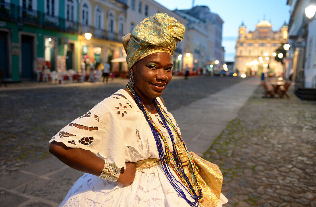 Afro-Brazilian woman wearing traditional Bahian dresses in Salvador da Bahia, the city of the Holy Saviour of the Bay of all Saints on the northeast coast of Brazil , South America
