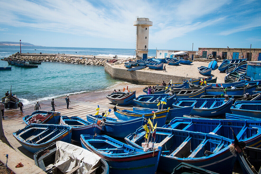 Blue boats docked on boat ramp