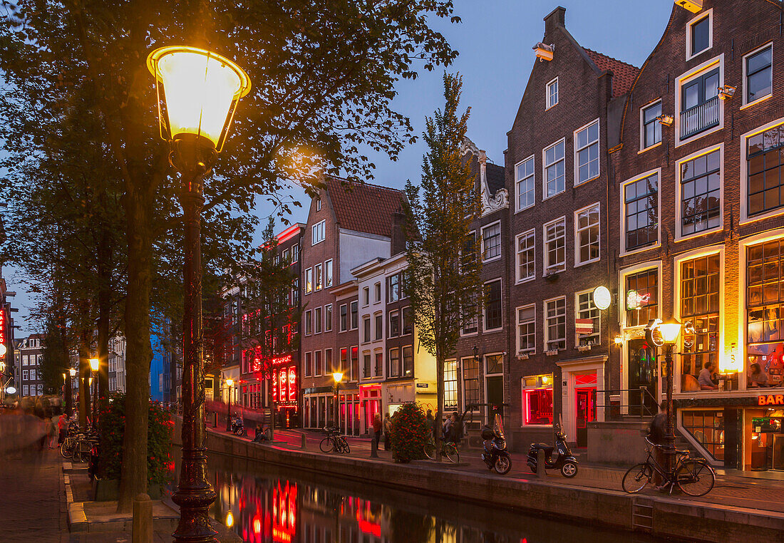 Illuminated streetlights on Amsterdam canal street, Netherland