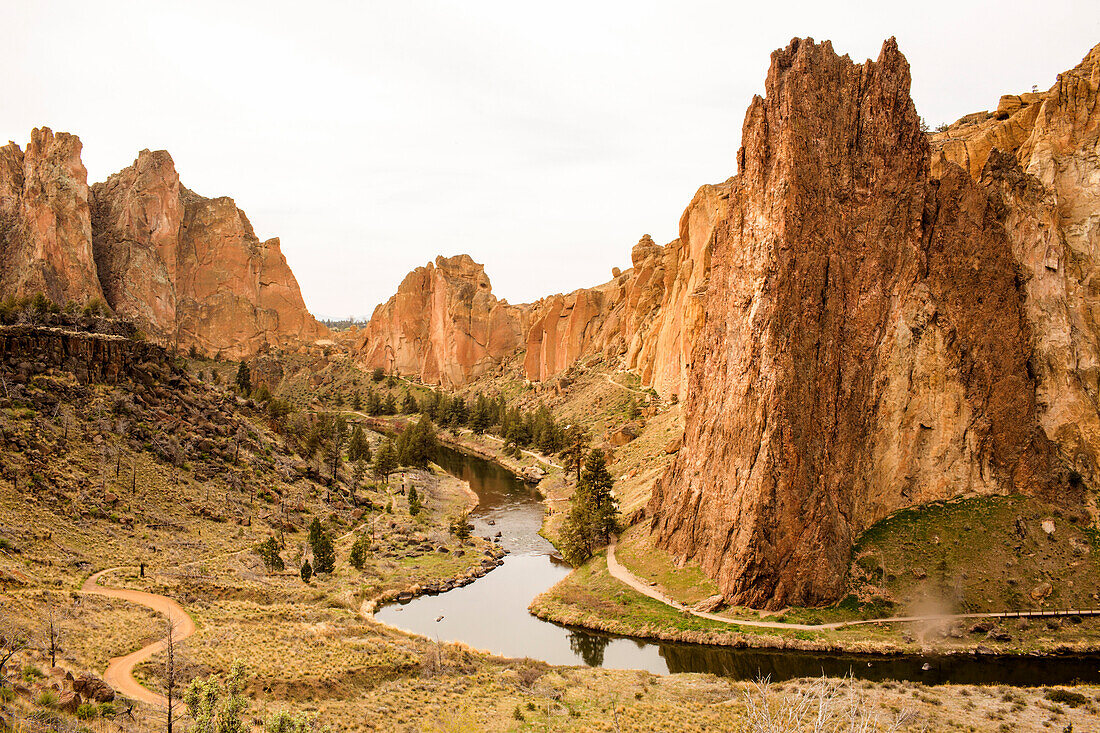 Stream through sheer cliffs in desert landscape, Smith Rock State Park, Oregon, United States