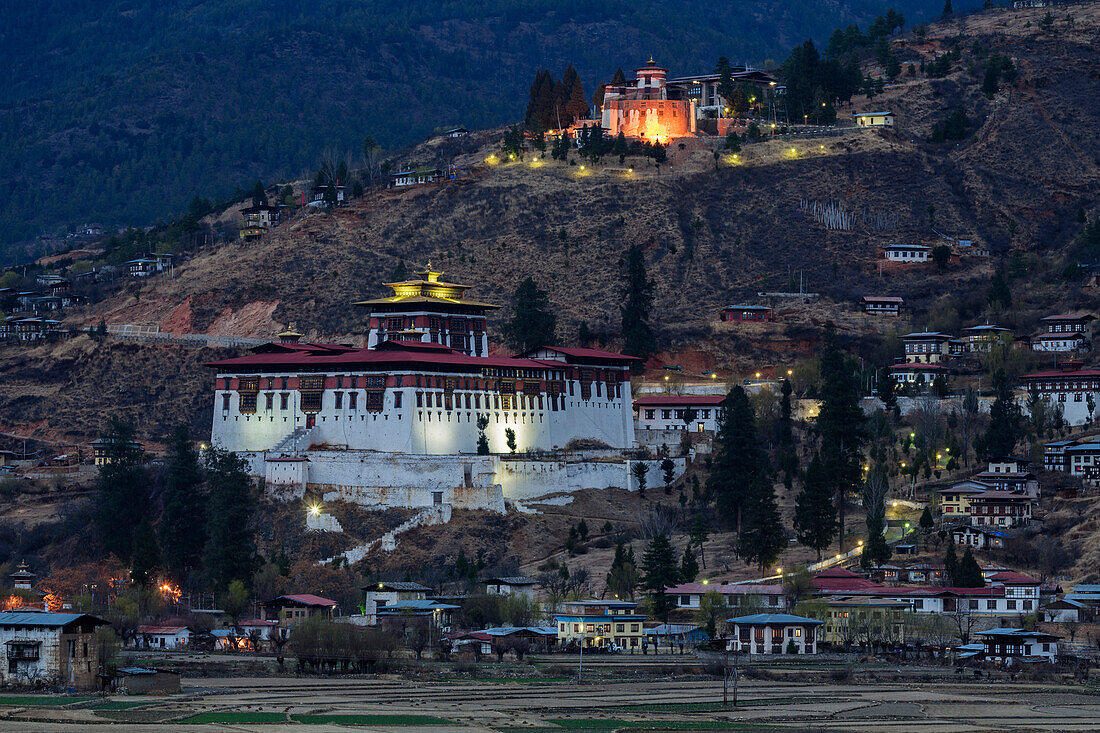 Illuminated buildings on remote hillside, Paro, Paro District, Bhutan