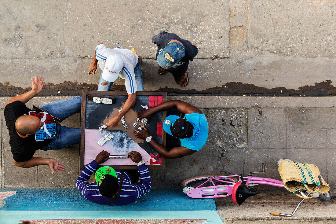 Overhead view of men playing dominoes on Camaguey street, Camaguey, Cuba