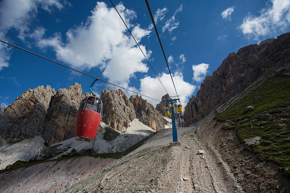 Low angle view of gondolas on line up remote mountainside