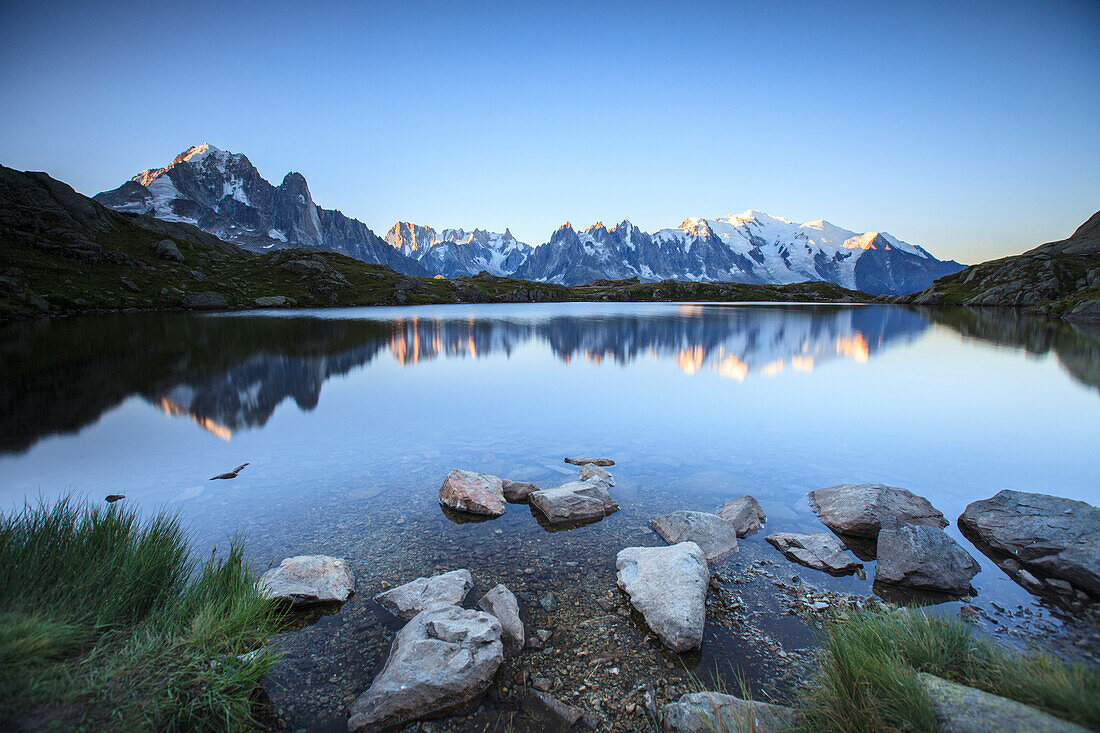 Mont Blanc range reflected at sunrise from the shore of Lac des Cheserys, Aiguilles Rouges, Chamonix, Haute Savoie, French Alps, France, Europe