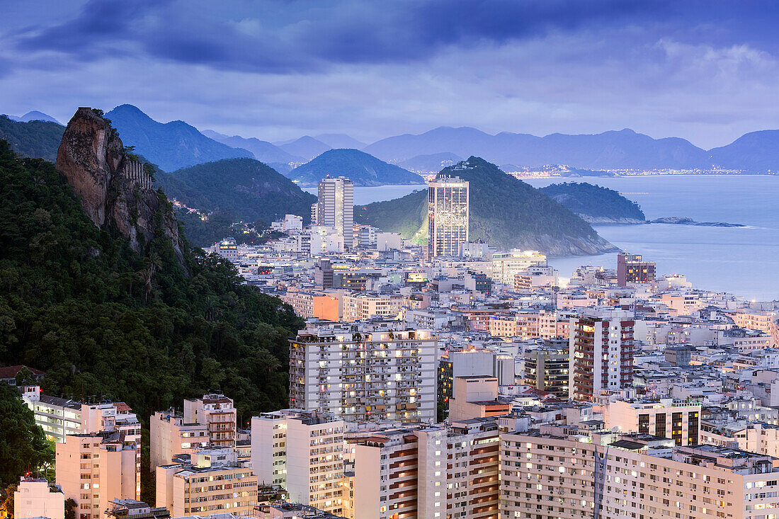 Twilight, illuminated view of Copacabana, the Morro de Sao Joao and the Atlantic coast of Rio, Rio de Janeiro, Brazil, South America