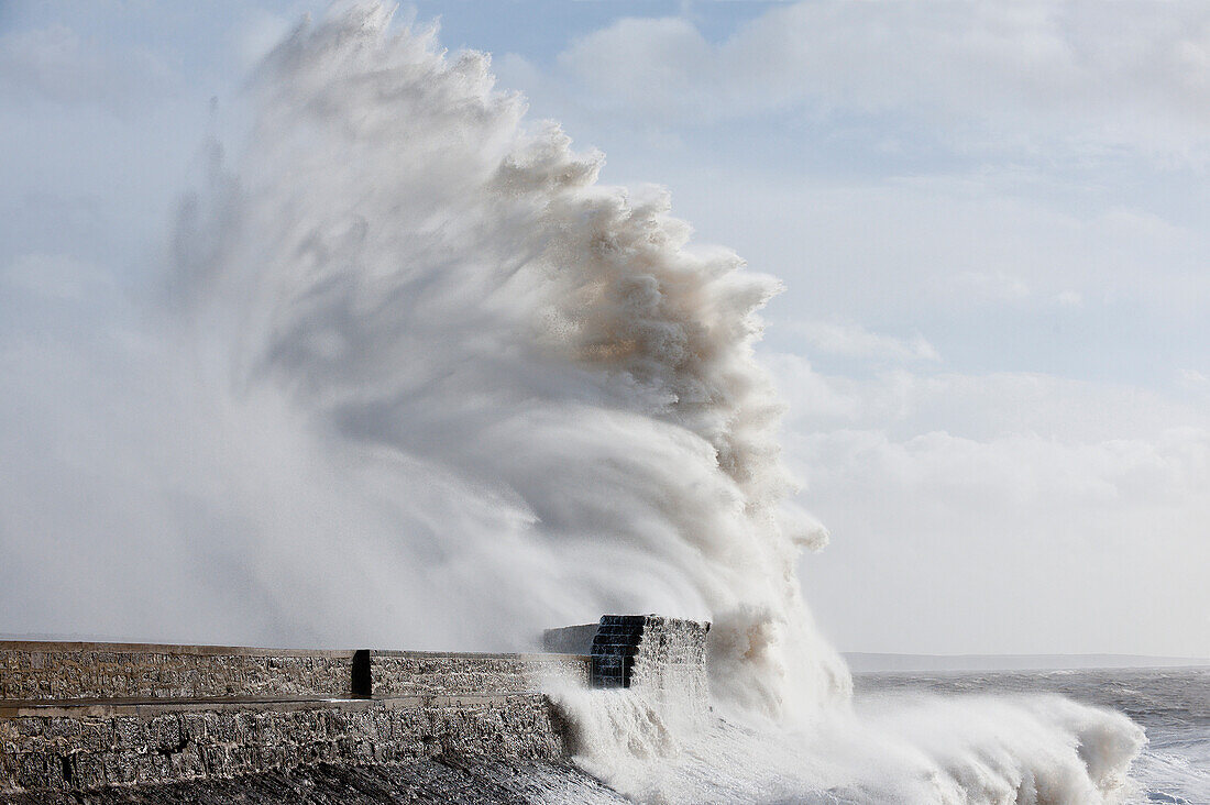 Waves crash against the harbour wall at Porthcawl, Bridgend, Wales, United Kingdom, Europe
