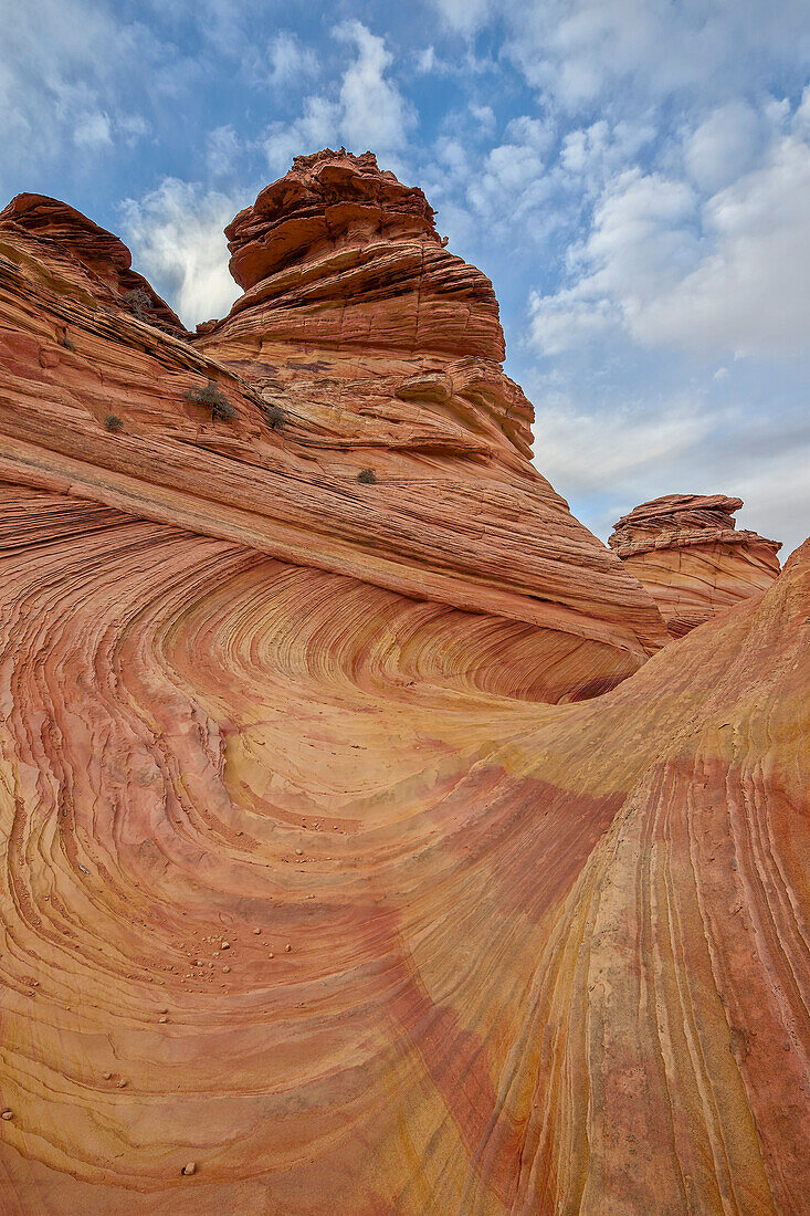 Sandstone wave and cones under clouds, Coyote Buttes Wilderness, Vermilion Cliffs National Monument, Arizona, United States of America, North America