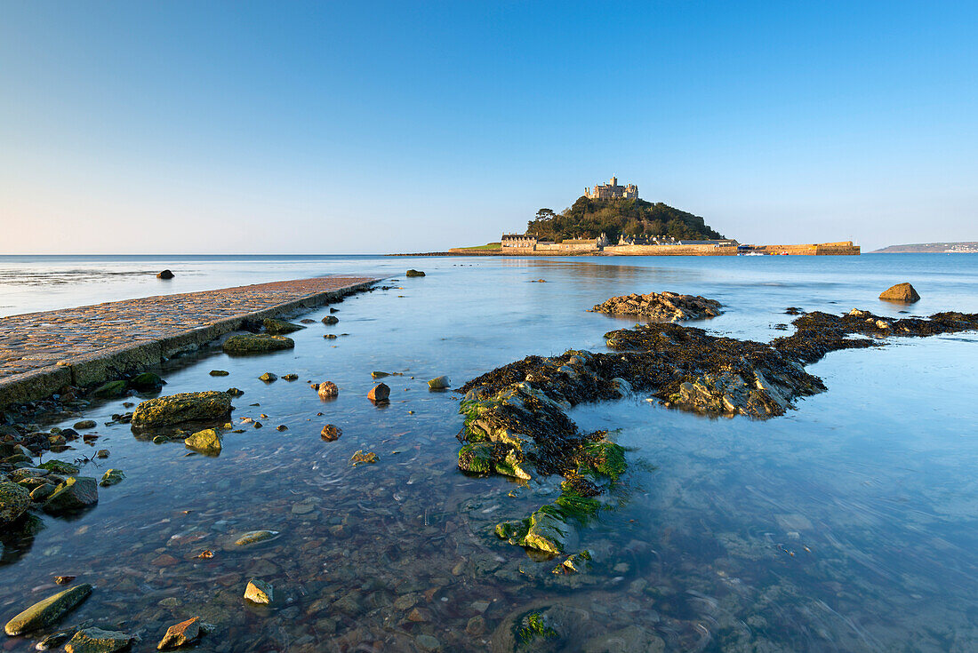 Rising tide floods Mounts Bay and the stone causeway at St. Michaels Mount, Marazion, Cornwall, England, United Kingdom, Europe