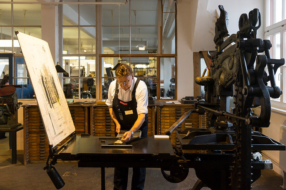 Museum of Printing Arts Leipzig, worker at the printing machine, type foundry, Leipzig, Saxony, Germany