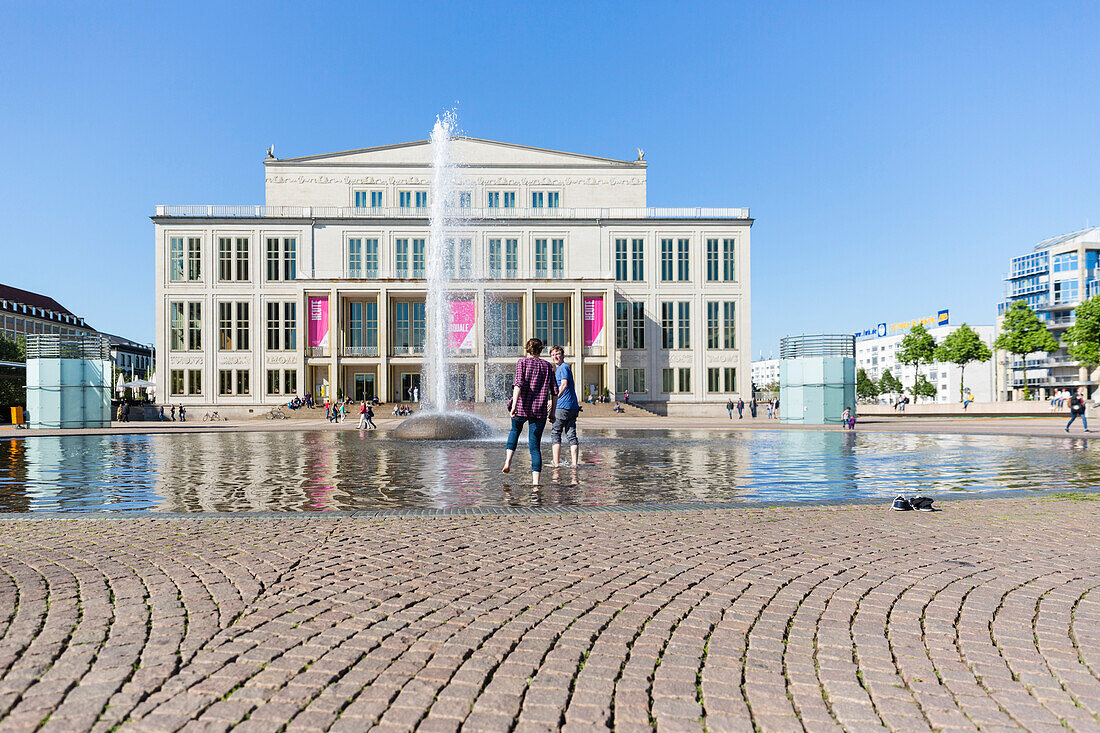 Opera Leipzig in summer with fountain on square, people bathing their feet, Augustusplatz, Leipzig, Saxony, Germany