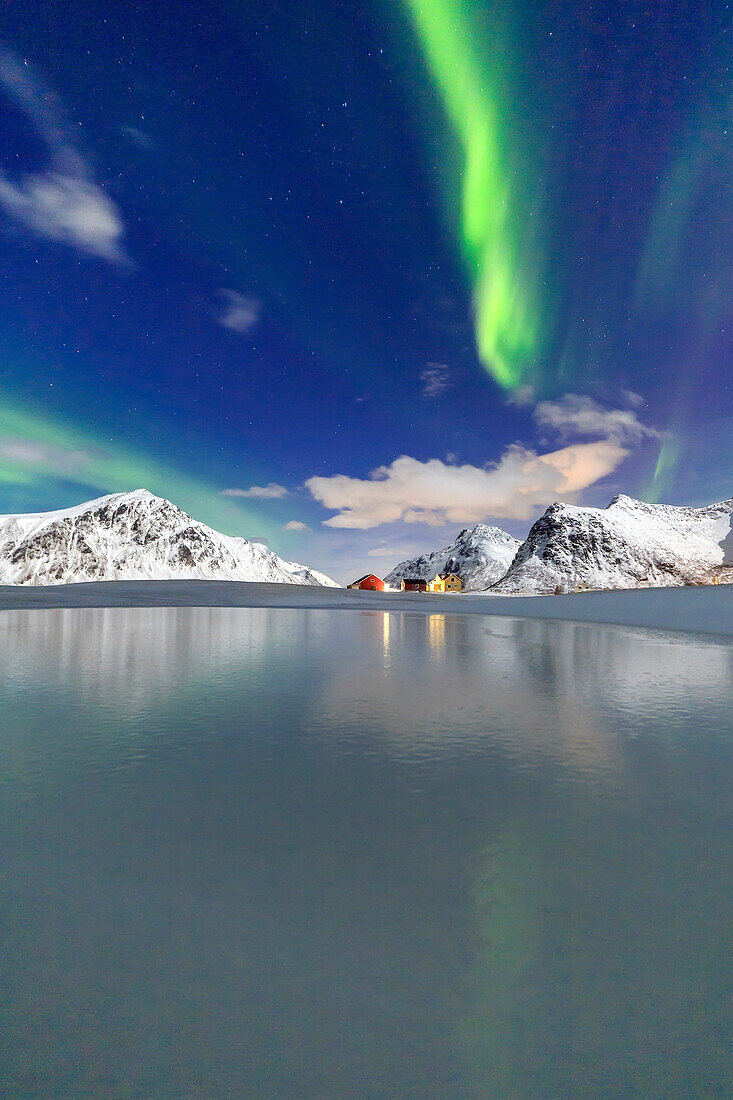 Northern Lights (aurora borealis) reflected in the cold waters, Flakstad, Lofoten Islands, Arctic, Norway, Scandinavia, Europe