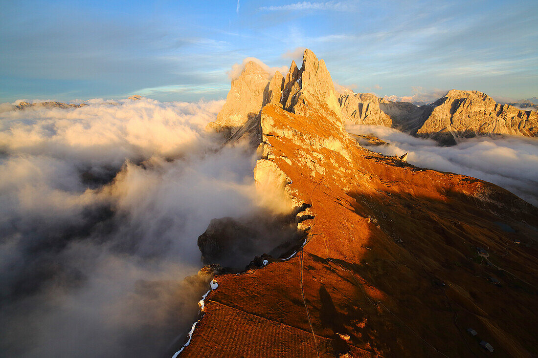 Aerial shot from Seceda of Odle surrounded by clouds at sunset in the Dolomites, Val Funes, Trentino Alto-Adige South Tyrol, Italy, Europe