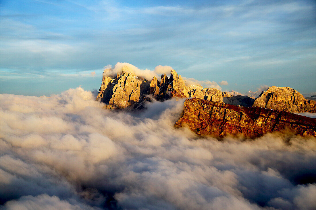 Aerial shot from Seceda of Odle surrounded by clouds at sunset in the Dolomites, Val Funes, Trentino-Alto Adige South Tyrol, Italy, Europe