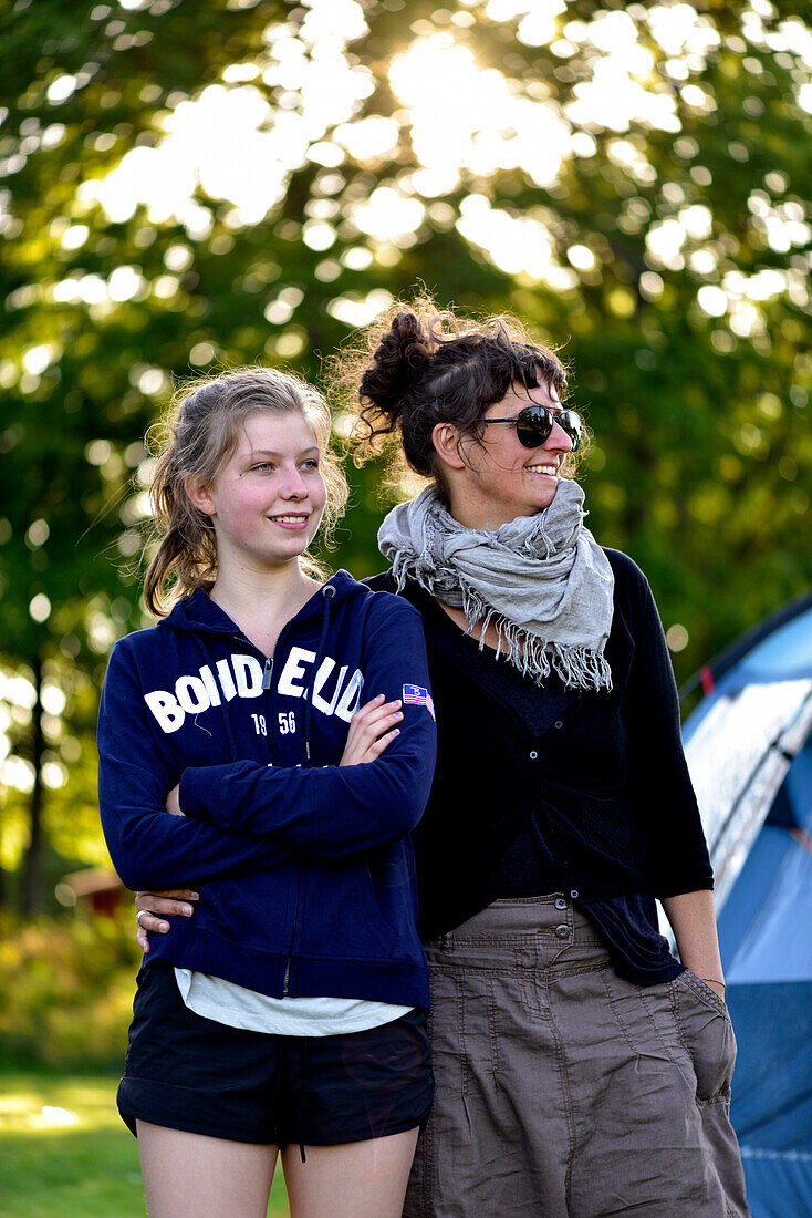 Mother and daughter outside in front of tent, camping ground, Vaestervik, Smaland, Sweden
