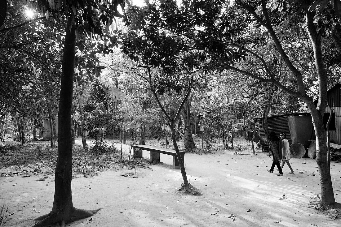 Two girls walking through the woods in Munshiganji, Bangladesh