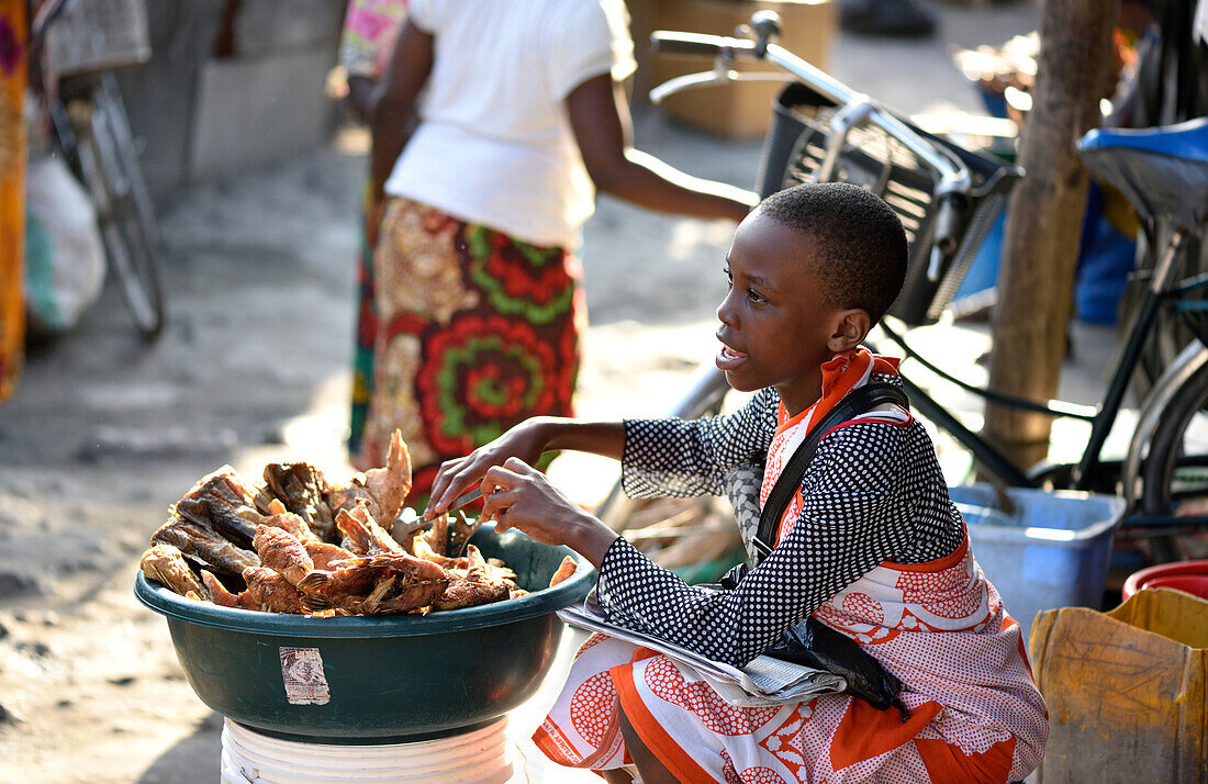 Women selling fried fish on the market, Kigamboni, Tanzania, Africa
