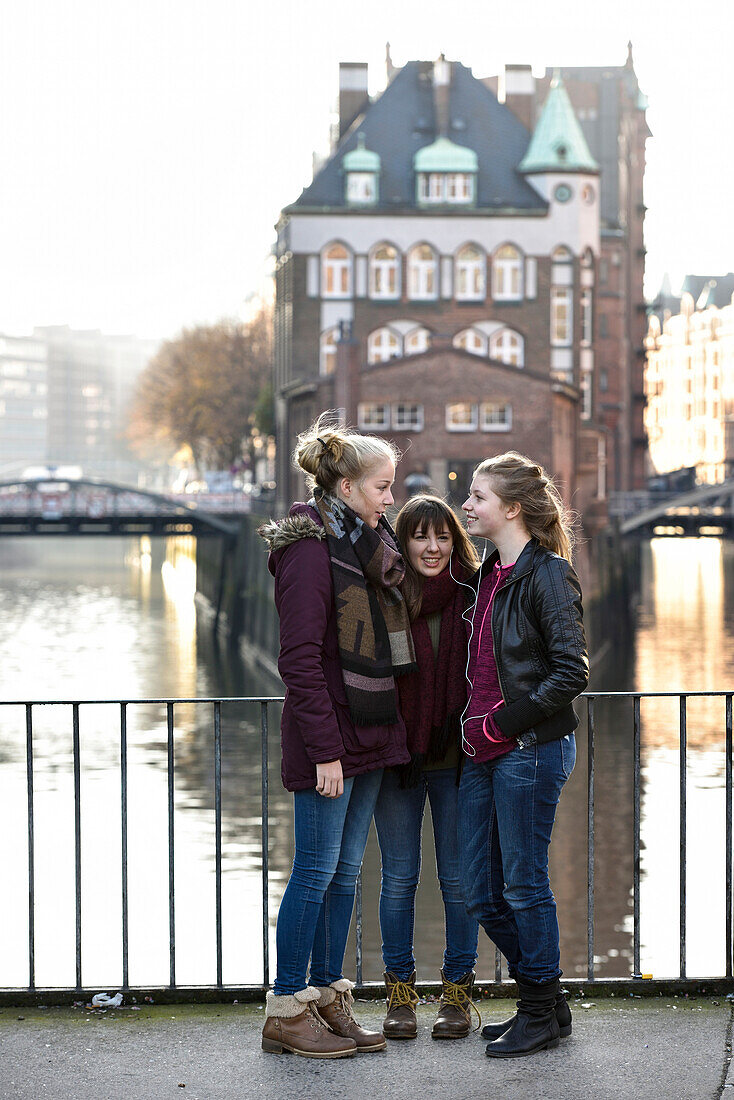 3 girls talking outside, Speicherstadt, Hamburg, Germany, Europe