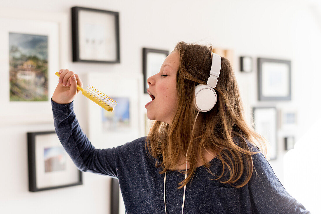 Girl singing Karaoke in the living room, Hamburg, Germany, Europe