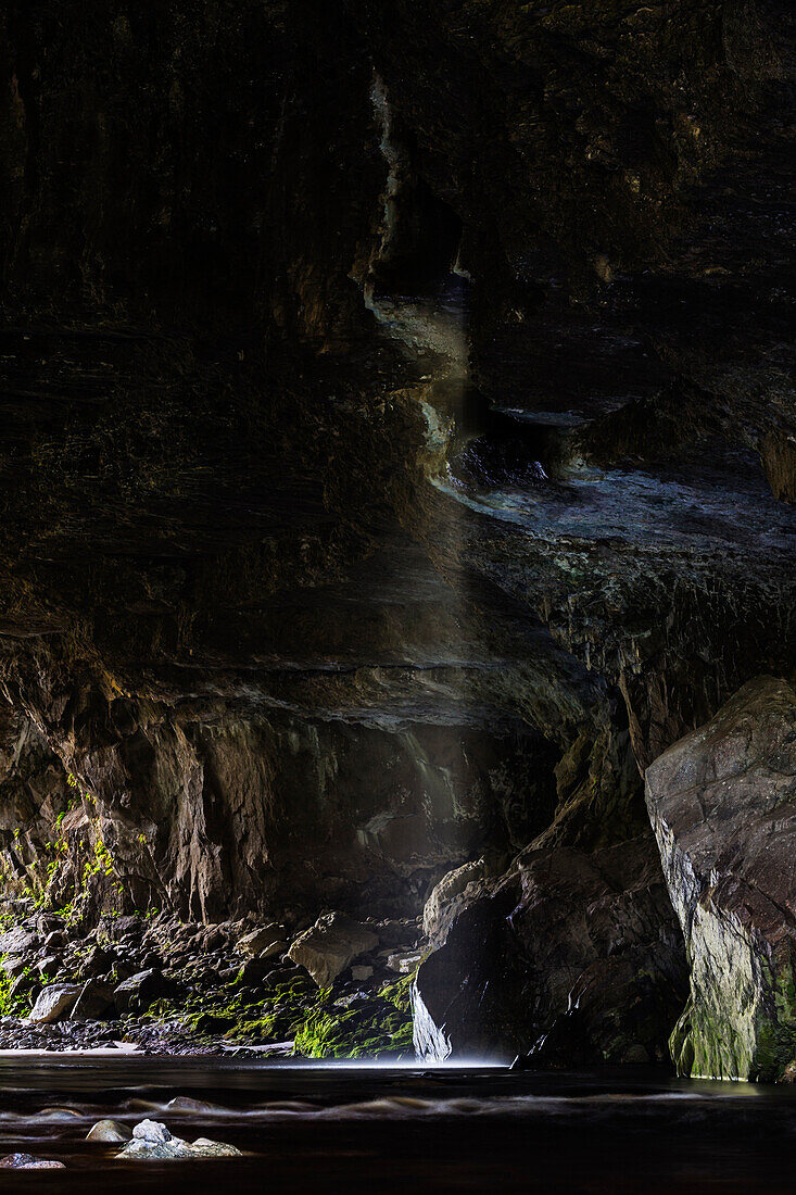 Water flowing through rocky ocean cave