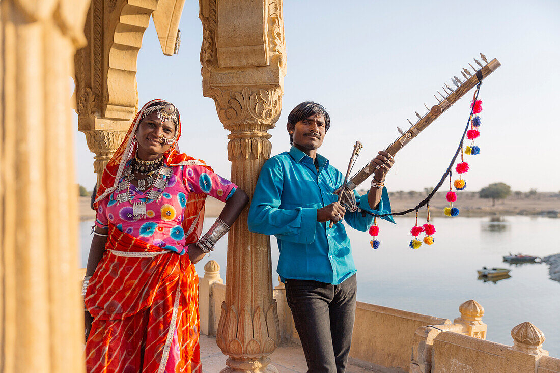 Traditional Indian couple standing in monument, Jaisalmer, Rajasthan, India