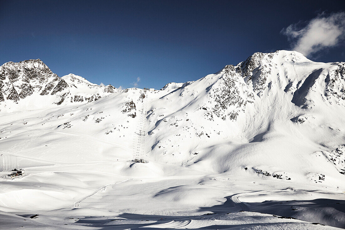 Sunny snowy mountains and ski resort, Schnalstaler Glacier, South Tirol, Italy