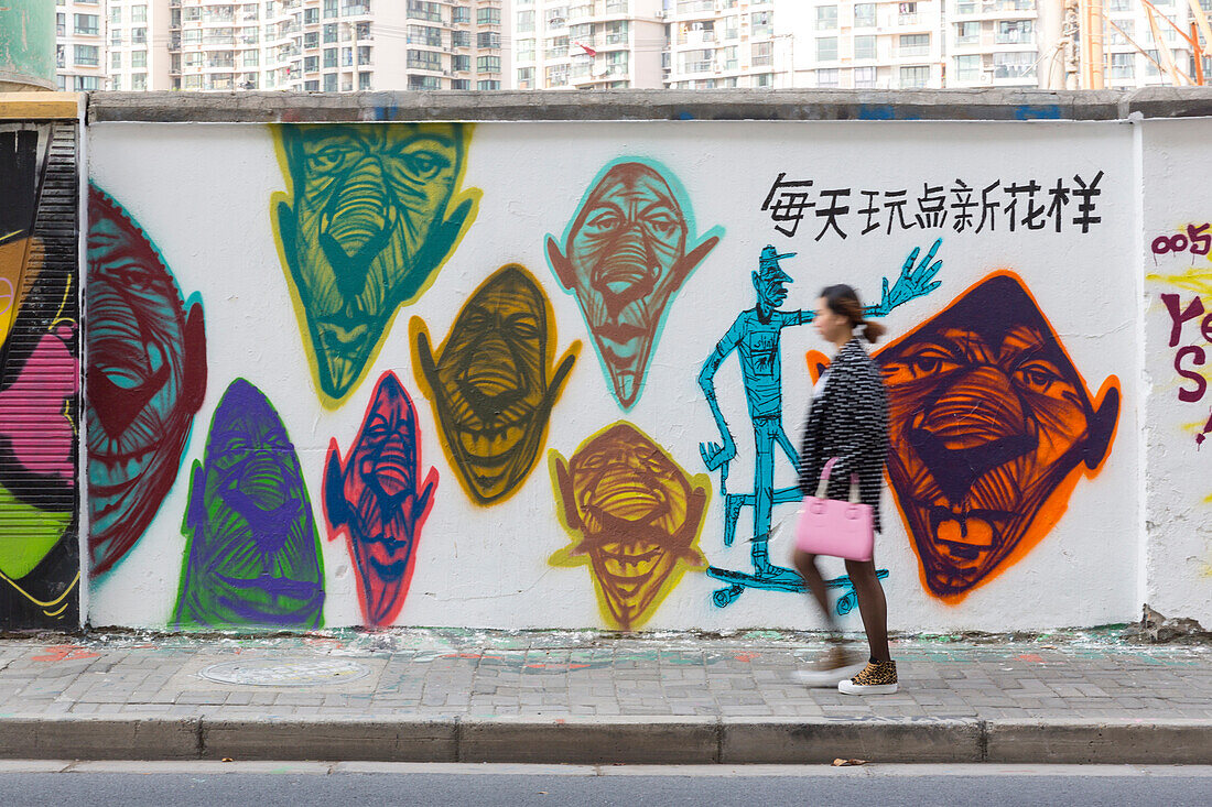 Funny graffiti on wall on Moganshan Road, women passing, street art, Art district at Wusong River, Putuo District, Shanghai, China, Asia