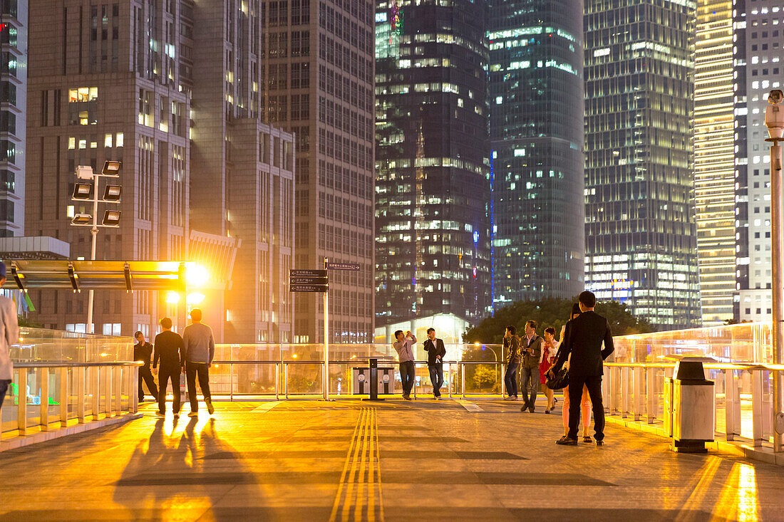 Night, Pudong, people on bridge, walkway, skyscraper, illuminated, office spaces, financial district, Shanghai, China, Asia