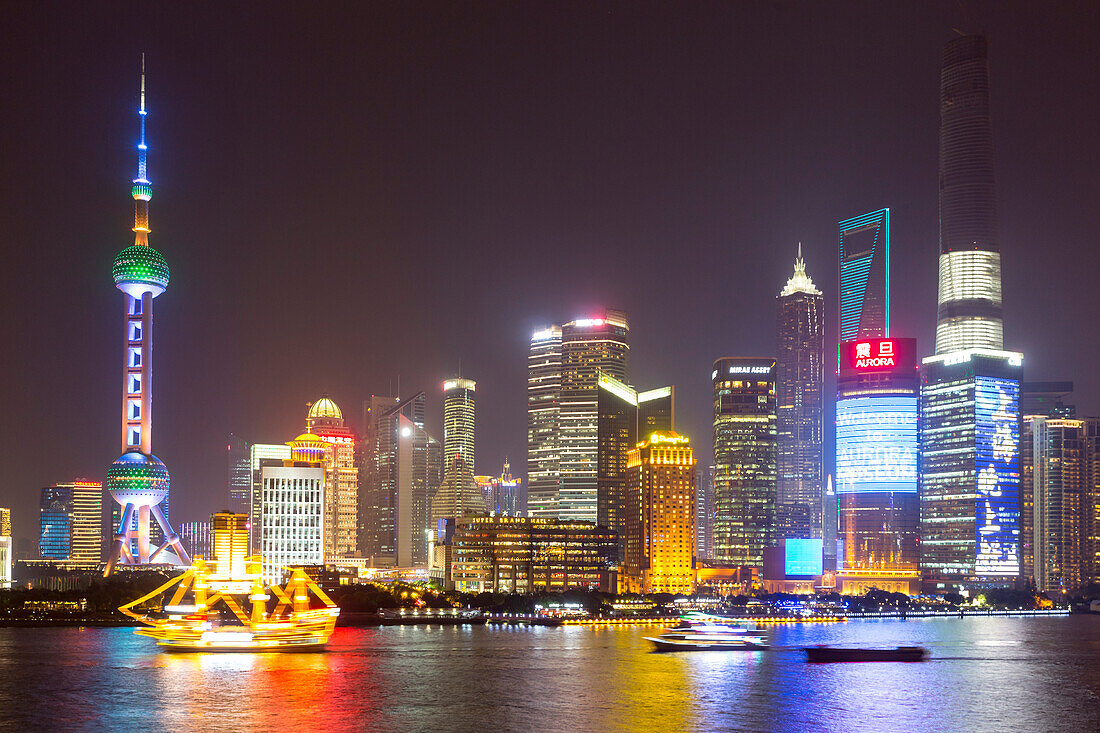 Evening on the Bund, night skyline of Shanghai, Oriental Pearl Tower, Jinmao Tower, Shanghai World Financial Center, Shanghai Tower, illuminated boat on Huangpu River, Shanghai, China, Asia